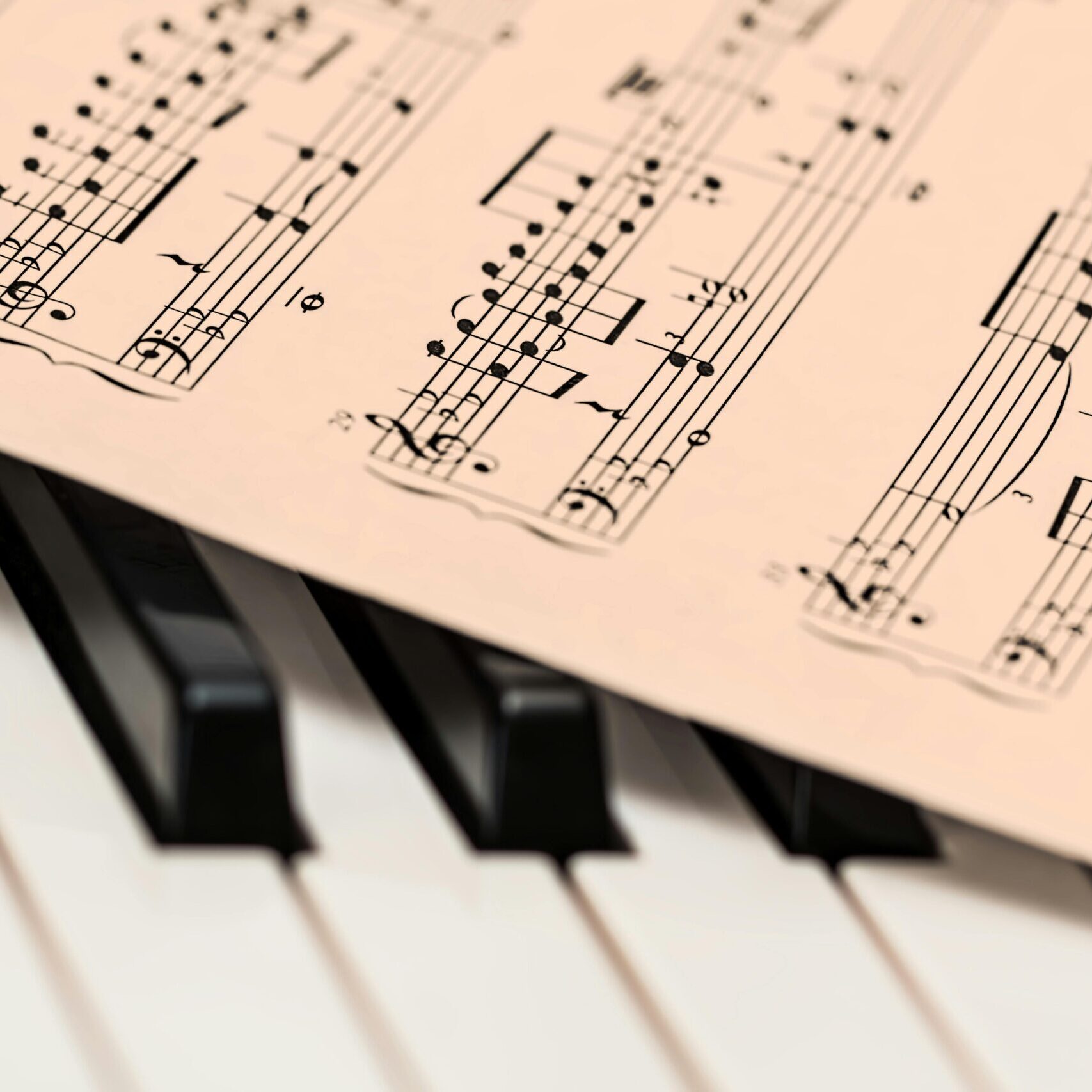 Black and white piano keys with a sheet of classical music creating a harmonious composition.